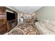 Open-concept living space with modern furnishings and a view of the kitchen at 5743 Bungalow Grove Ct, Palmetto, FL 34221