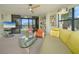 Bright living room featuring sliding glass doors with balcony access and contemporary decor at 5780 Midnight Pass Rd # 210, Sarasota, FL 34242