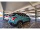 Covered parking area with assigned parking spaces and a well-maintained paved surface at 5780 Midnight Pass Rd # 210, Sarasota, FL 34242