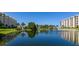 Scenic lake with fountain is surrounded by lush landscaping and condominium buildings at 5780 Midnight Pass Rd # 210, Sarasota, FL 34242