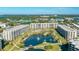 Enjoy a resort-style pool, lake with fountains, lush landscaping, and beach access in this condo community at 5780 Midnight Pass Rd # 210, Sarasota, FL 34242