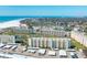 Stunning aerial view of the beachfront condo community, with expansive white sand beaches and turquoise ocean waters at 5780 Midnight Pass Rd # 210, Sarasota, FL 34242