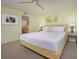 Bedroom featuring a bed with side tables, art, and an ensuite bathroom at 5780 Midnight Pass Rd # 210, Sarasota, FL 34242