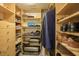 Spacious walk-in closet with custom shelving and organization systems for clothes, shoes, and accessories at 5780 Midnight Pass Rd # 210, Sarasota, FL 34242