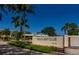 Entrance to Gulf & Bay Club with well-maintained landscaping at 5780 Midnight Pass Rd # 210, Sarasota, FL 34242