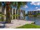Picturesque pond with a fountain, lush greenery, and birds, surrounded by residential buildings in the community at 5780 Midnight Pass Rd # 210, Sarasota, FL 34242