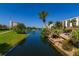 Scenic pond view with lush landscaping, palm trees, and seating areas, creating a serene atmosphere at 5780 Midnight Pass Rd # 210, Sarasota, FL 34242