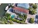 Aerial view of a property with a pool, boat dock, and lush tropical landscaping on a waterfront lot at 601 Avenida De Mayo, Sarasota, FL 34242