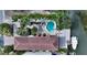 Aerial view of luxurious home with private pool, patio, lush landscaping, and boat dock at 601 Avenida De Mayo, Sarasota, FL 34242