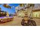 A peaceful backyard with a pool, stone fountain, comfortable seating, and ambient string lights at 601 Avenida De Mayo, Sarasota, FL 34242
