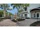 Picturesque backyard with a fountain, outdoor seating, pool and lush landscaping with string lights at 601 Avenida De Mayo, Sarasota, FL 34242