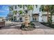 Picturesque backyard featuring a stone fountain, seating areas, and lush landscaping at 601 Avenida De Mayo, Sarasota, FL 34242