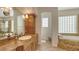 Well-lit bathroom featuring a soaking tub, walk-in shower, and granite countertop at 601 Avenida De Mayo, Sarasota, FL 34242