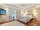 Bright bedroom featuring a sitting area, hardwood floors, and double doors to an office at 601 Avenida De Mayo, Sarasota, FL 34242