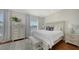 Bright bedroom featuring natural light, wood floors, a plush bed, and sophisticated decor at 601 Avenida De Mayo, Sarasota, FL 34242