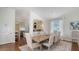 Dining room with hardwood floors, view into the kitchen and seating for six at 601 Avenida De Mayo, Sarasota, FL 34242