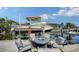 Waterfront dock with boat lift, fire pit and comfortable seating, ideal for relaxing by the water at 601 Avenida De Mayo, Sarasota, FL 34242