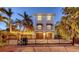 Beautiful two-story home with a brick driveway, black iron gate and illuminated outdoor space at 601 Avenida De Mayo, Sarasota, FL 34242