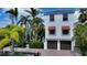 Charming two-story home with two-car garage, brick driveway and beautifully landscaped yard with mature palm trees at 601 Avenida De Mayo, Sarasota, FL 34242