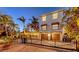 Charming two-story home with two-car garage, brick driveway and beautifully landscaped yard with mature palm trees at 601 Avenida De Mayo, Sarasota, FL 34242