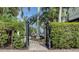 Arched gateway entrance to the outdoor space, featuring a decorative fountain and lush landscaping at 601 Avenida De Mayo, Sarasota, FL 34242