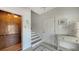 Bright hallway featuring stairs, an elevator, and a white interior door at 601 Avenida De Mayo, Sarasota, FL 34242