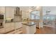 Gourmet kitchen featuring a center island, stainless appliances, and an open view to the dining area at 601 Avenida De Mayo, Sarasota, FL 34242