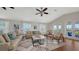 Bright living room featuring hardwood floors, neutral furniture, and access to a balcony at 601 Avenida De Mayo, Sarasota, FL 34242