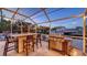 Screened outdoor kitchen with grill and bar seating, perfect for waterfront entertainment at 601 Avenida De Mayo, Sarasota, FL 34242