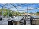 Screened outdoor kitchen area featuring a built-in grill and bar seating, perfect for waterfront entertaining at 601 Avenida De Mayo, Sarasota, FL 34242