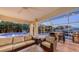Covered outdoor living space with comfortable seating, a grill, and waterfront views, ideal for relaxing and entertaining at 601 Avenida De Mayo, Sarasota, FL 34242