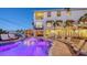 Backyard pool with night lighting and lush foliage, set against a beautiful and spacious multi-story home at 601 Avenida De Mayo, Sarasota, FL 34242