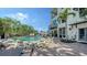 Inviting backyard pool area with comfortable seating, lush landscaping, and string lighting at 601 Avenida De Mayo, Sarasota, FL 34242