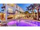 Backyard pool with night lighting and lush foliage, set against a beautiful and spacious multi-story home at 601 Avenida De Mayo, Sarasota, FL 34242