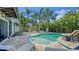 Inviting pool area featuring a freeform pool, comfortable lounge seating and meticulously maintained tropical landscaping at 601 Avenida De Mayo, Sarasota, FL 34242