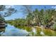 Waterfront scenery featuring lush greenery, a river and trees under a bright blue sky at 601 Avenida De Mayo, Sarasota, FL 34242