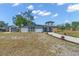 Single-story home with grey exterior, long driveway, and detached garage at 6512 Clemson St, Bradenton, FL 34207