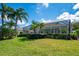 Expansive backyard with screened-in pool and lush landscaping at 7015 Stanhope Pl, University Park, FL 34201