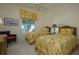 Cozy bedroom with twin beds, floral bedding, and a window offering natural light at 7015 Stanhope Pl, University Park, FL 34201