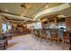 Comfortable club bar and lounge area with wood bar, leather chairs, and tile flooring at 7015 Stanhope Pl, University Park, FL 34201