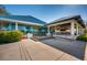 Spacious clubhouse with a turquoise roof, floor-to-ceiling windows, and an outdoor patio seating area at 7015 Stanhope Pl, University Park, FL 34201