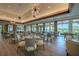 Beautiful dining room with lake views through large windows, and comfortable seating creating a warm atmosphere at 7015 Stanhope Pl, University Park, FL 34201