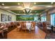 Dining room with decorative mural, neutral colored walls and curtains and tropical hanging light at 7015 Stanhope Pl, University Park, FL 34201
