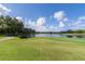 Scenic view of golf course with trees and blue skies, perfect for a day on the links at 7015 Stanhope Pl, University Park, FL 34201