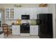 Stylish kitchen featuring sleek black appliances, white cabinets, and a cozy breakfast nook. Perfect for entertaining at 7015 Stanhope Pl, University Park, FL 34201