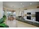 Lovely kitchen featuring light tile flooring, black appliances, white cabinets and a breakfast nook with large windows at 7015 Stanhope Pl, University Park, FL 34201