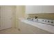 Functional laundry room featuring modern appliances, a utility sink, and ample storage space at 7015 Stanhope Pl, University Park, FL 34201