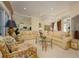 Spacious living room with ample seating, a glass coffee table, and views into the kitchen and dining areas at 7015 Stanhope Pl, University Park, FL 34201