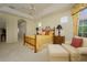 Inviting main bedroom with tray ceilings, ceiling fan, a bay window and seating area at 7015 Stanhope Pl, University Park, FL 34201