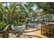 Outdoor deck with green trees and greenery, patio tables and chairs and views of the surrounding area at 7015 Stanhope Pl, University Park, FL 34201